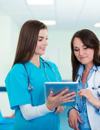 female-doctors-checking-results-digital-tablet
